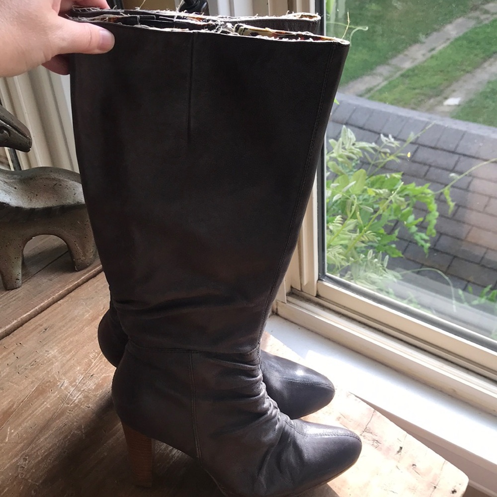 Tall leather boots with heel.